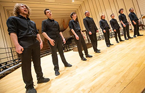 a row of men standing on a stage