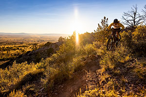 person biking on the side of a hill