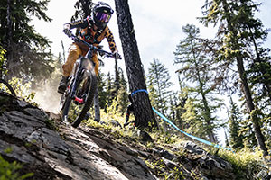 person riding a mountain bike down a rocky slope