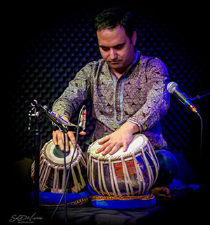 man playing hand drums