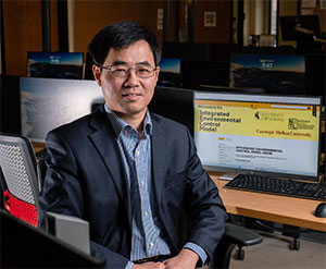 man sitting beside a desk with a computer