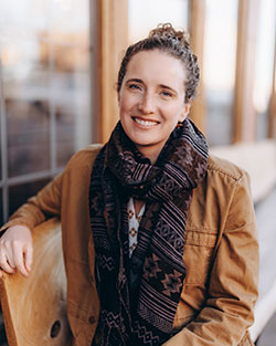woman sitting outside near windows