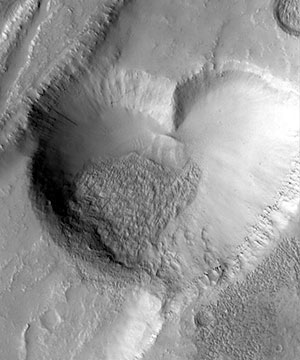 black and white photo of a heart-shaped crater on Mars