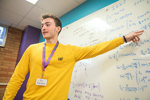man pointing to something on a whiteboard
