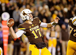 football player throwing football