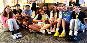 group of people posing together sitting on the floor