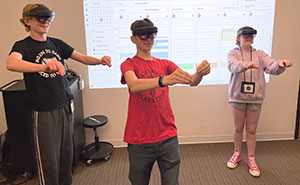 three teenagers wearing AR goggles