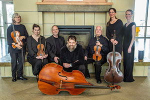 group of people with musical instruments posing together