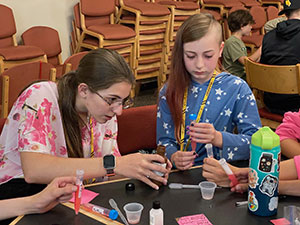 person working with a young girl at at table