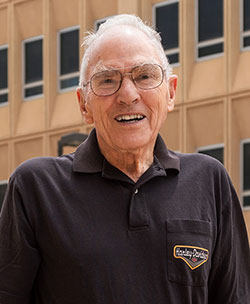 older man standing outside by a building