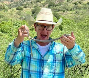 man holding up a snake