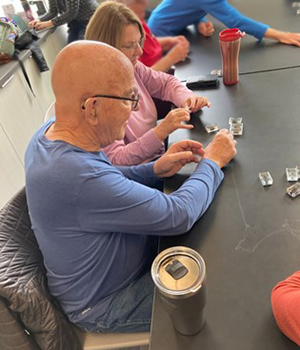 two people at a table working on a project