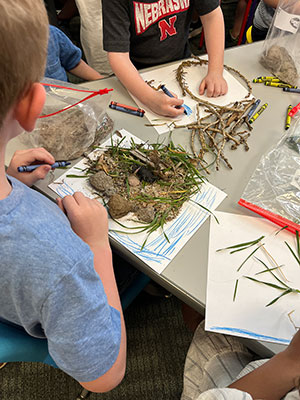 children working with natural materials at a table