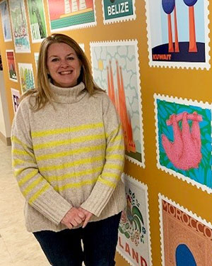 woman posing in a hall of artwork