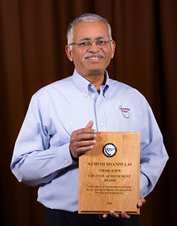man holding an award plaque