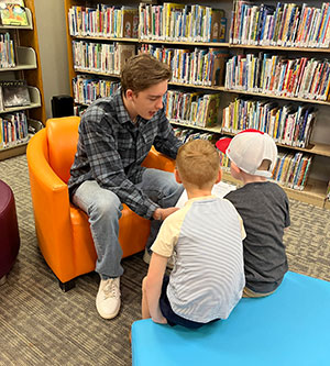 Someone reading to two children