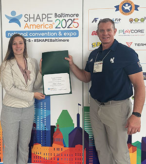 woman accepting award certificate from a man