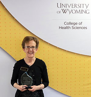 woman holding an award