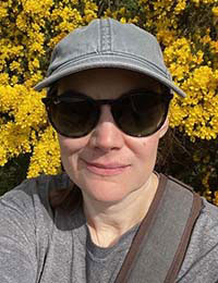 woman in baseball cap and sunglasses