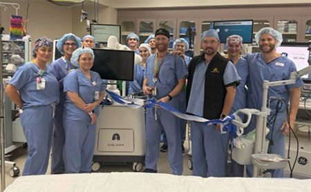 group of people wearing scrubs posing in a surigical suite