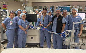 people in scrubs posing in a surgical suite