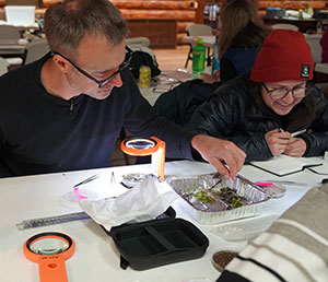 two people working together on a project at a table