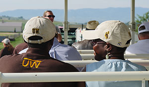 people listening to a speaker outdoors