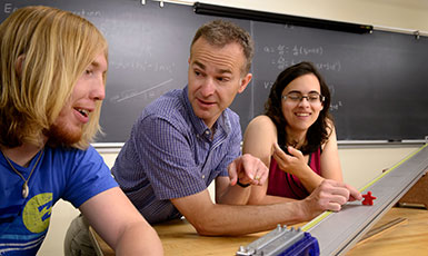three people at a table talking