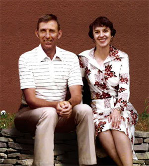 old photo of man and woman sitting together outside