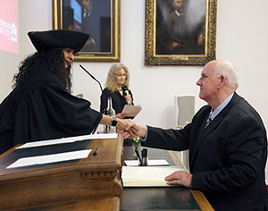 man shaking hands with a woman at a podium