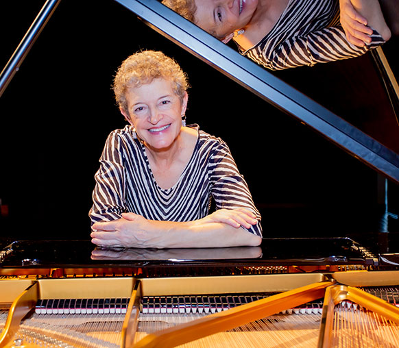 woman seated at a piano