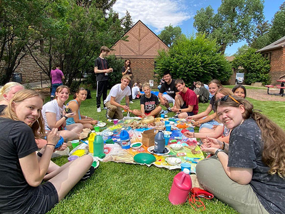 group outside on blankets on the grass