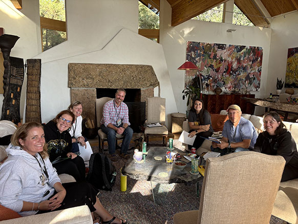 people gathered in a room with artwork on the walls