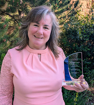 woman holding an award plaque