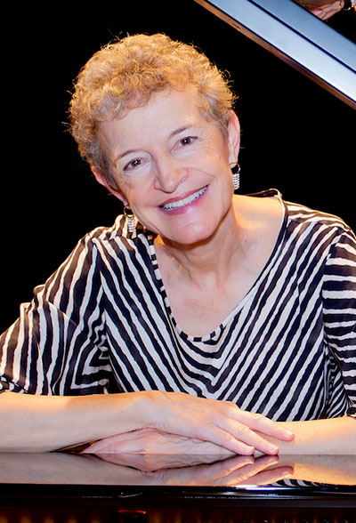 woman sitting at a piano