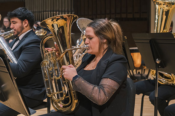 woman playing a low brass instrument