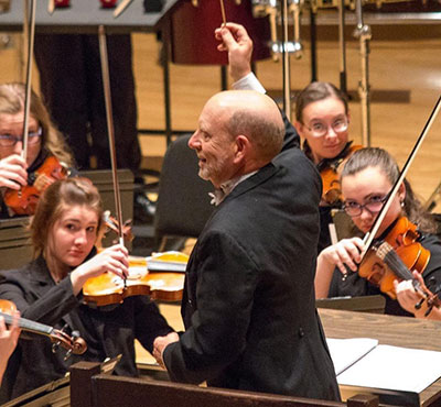 man conducting an orchestra