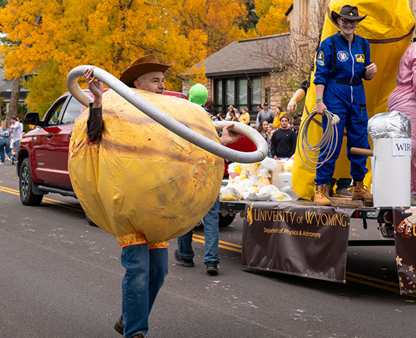 man costumed as a planet