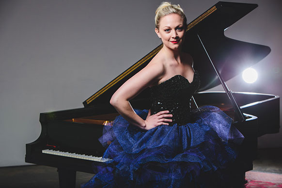 woman sitting beside a piano