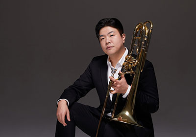 man posing with a trombone