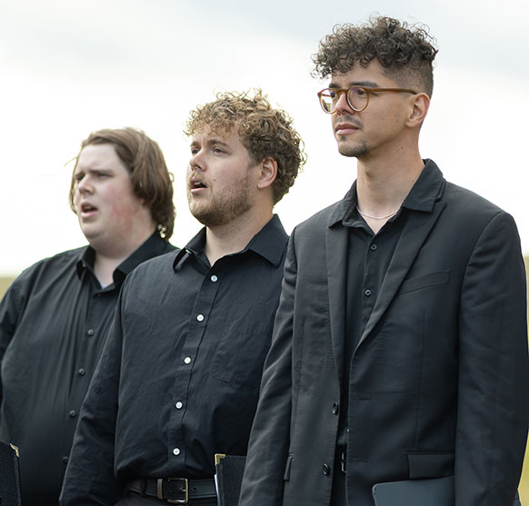 three men dressed in black