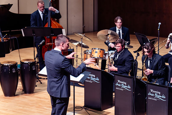 person conducting people playing instruments