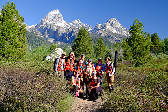 group of people with mountains in the background