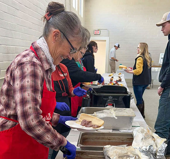 people serving food in a line