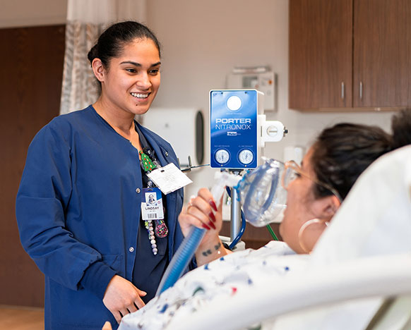 person talking to someone in a hospital bed