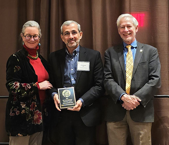 three people posing together