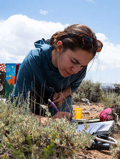 woman lying on the ground writing