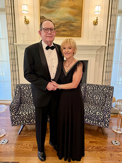 man and woman in formal wear posing together