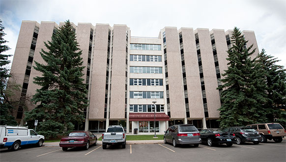 large building with cars parked in front of it