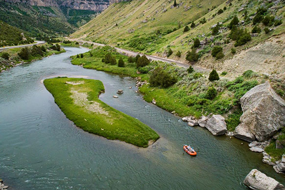 overhead view of a raft on a river between hills